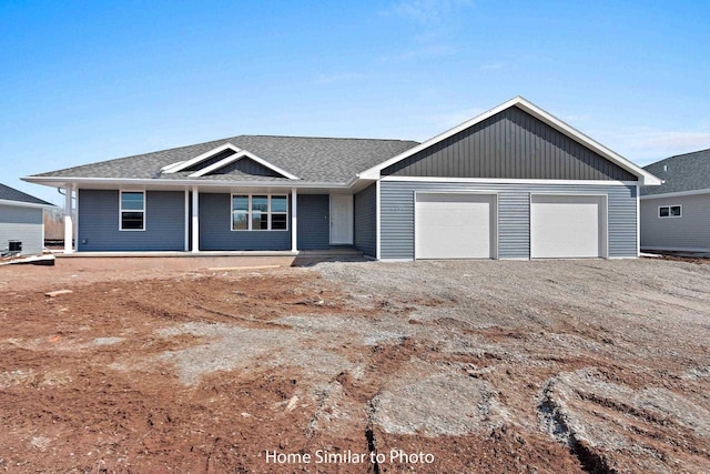 single story home featuring a garage, roof with shingles, and driveway