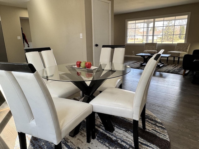 dining area featuring baseboards and wood finished floors