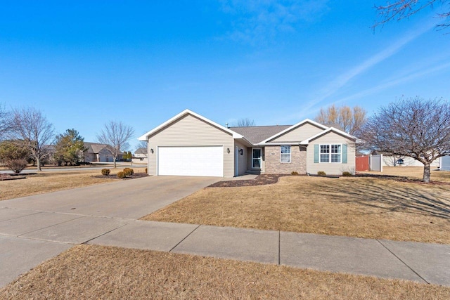 ranch-style house featuring a front lawn, an attached garage, and driveway