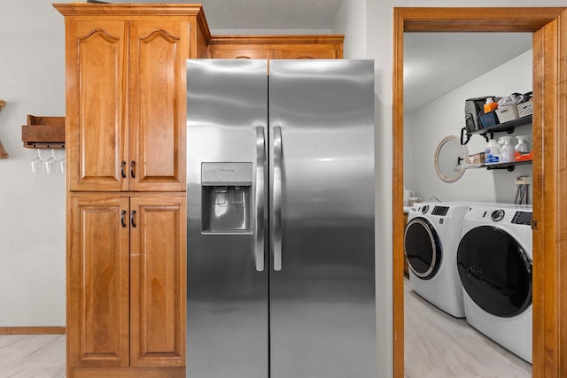 kitchen with stainless steel fridge, separate washer and dryer, and brown cabinets