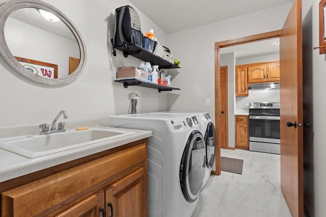 laundry area featuring a sink, cabinet space, marble finish floor, and washing machine and dryer