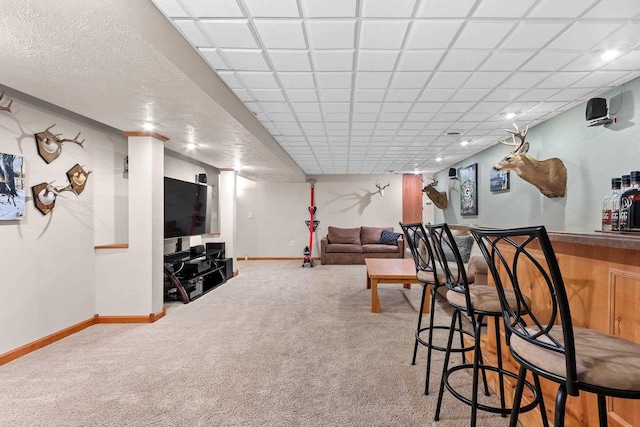 bar featuring a bar, baseboards, and carpet floors