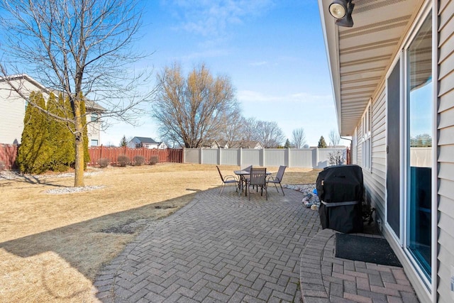 view of patio / terrace featuring outdoor dining area, a fenced backyard, and grilling area