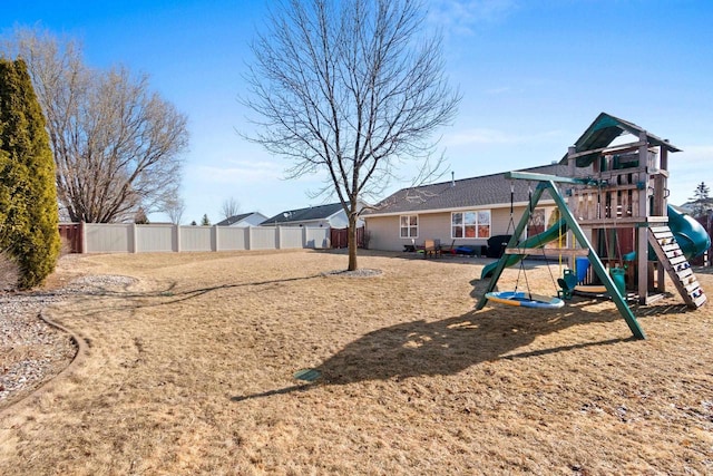 view of yard featuring a playground and fence