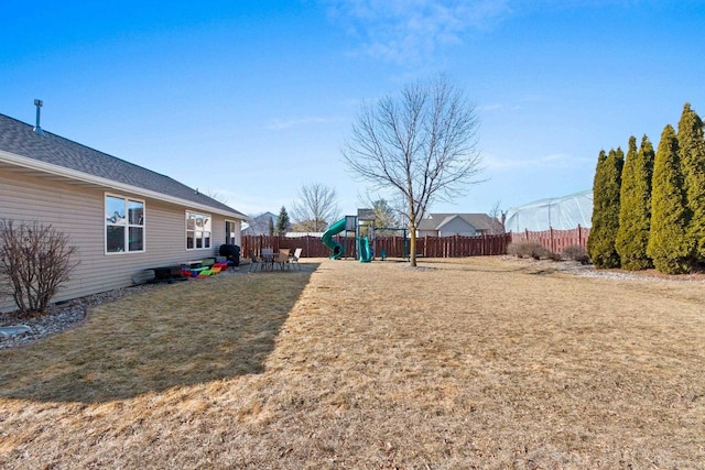 view of yard featuring a playground and fence