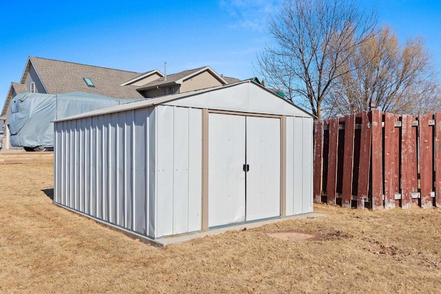 view of shed with fence