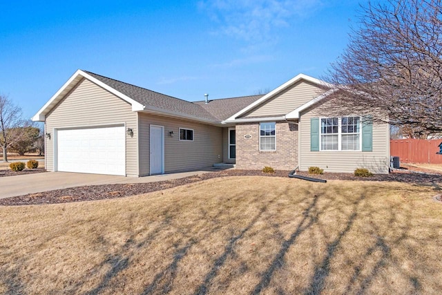 ranch-style home featuring brick siding, concrete driveway, a front yard, and a garage