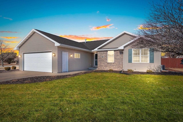 ranch-style home with brick siding, a front yard, concrete driveway, and an attached garage