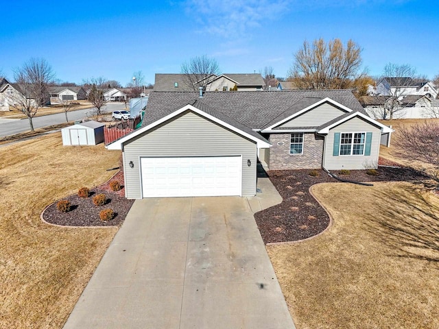 single story home with concrete driveway, a front lawn, a garage, a storage shed, and a residential view