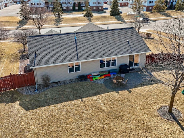 rear view of property with a patio area, a residential view, and fence