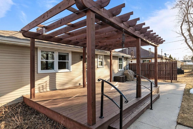 wooden deck featuring a pergola and fence