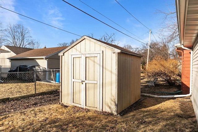 view of shed featuring fence