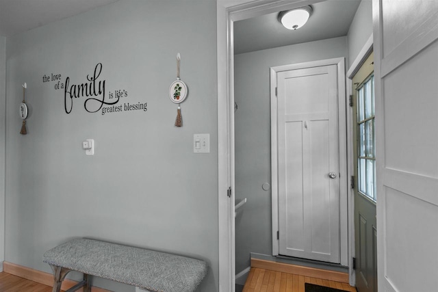 interior space with baseboards and wood finished floors