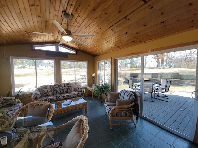 living area featuring lofted ceiling, dark tile patterned flooring, wood ceiling, and ceiling fan