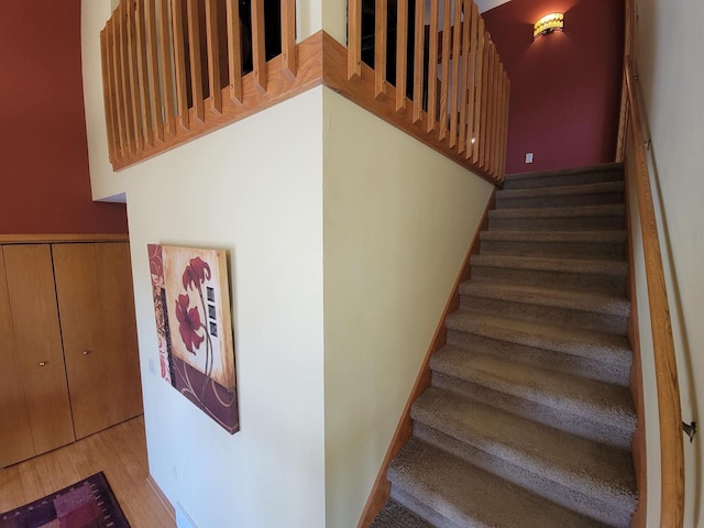 stairs featuring baseboards and wood finished floors