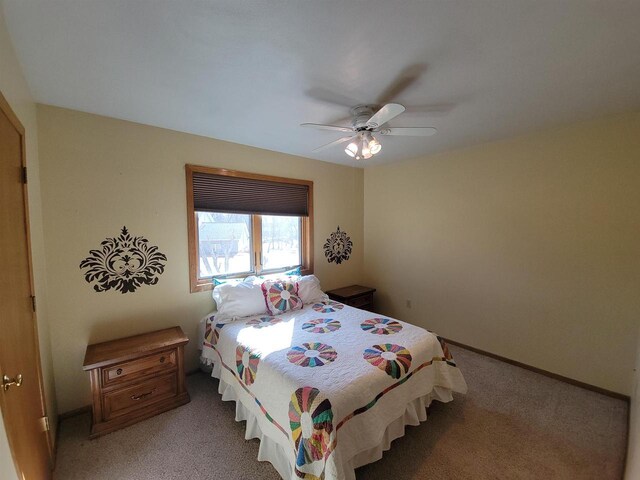 bedroom with baseboards, light carpet, and ceiling fan