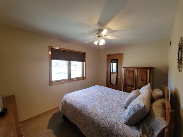 carpeted bedroom featuring baseboards and a ceiling fan