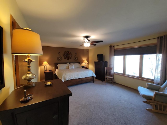 bedroom with a ceiling fan and carpet flooring