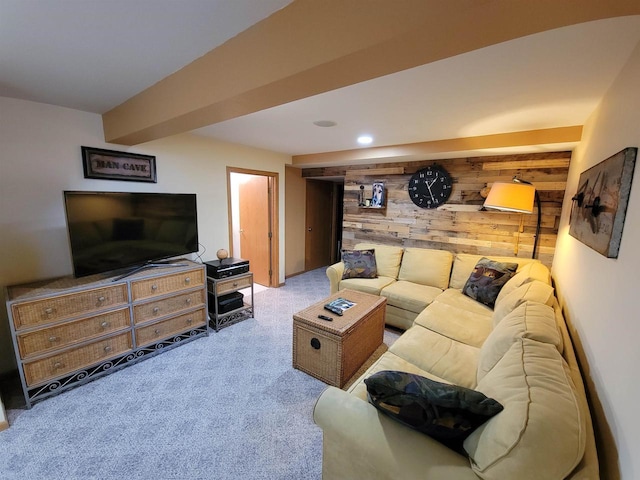 carpeted living room featuring beam ceiling and wooden walls