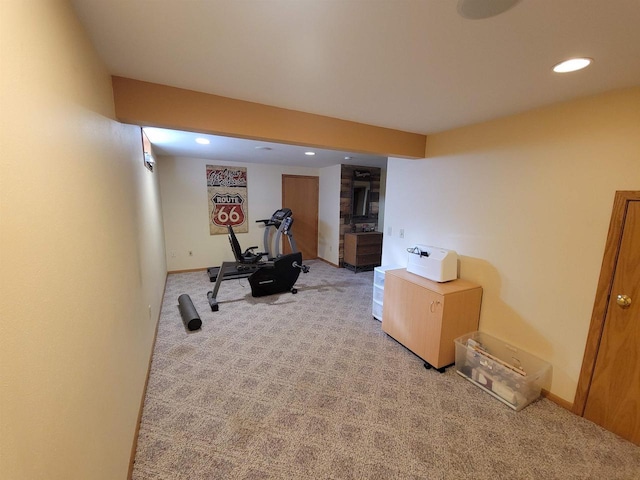 workout area with recessed lighting, baseboards, and light carpet