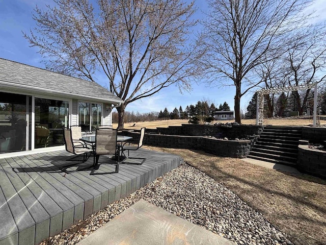 view of yard with stairway, outdoor dining area, and a wooden deck