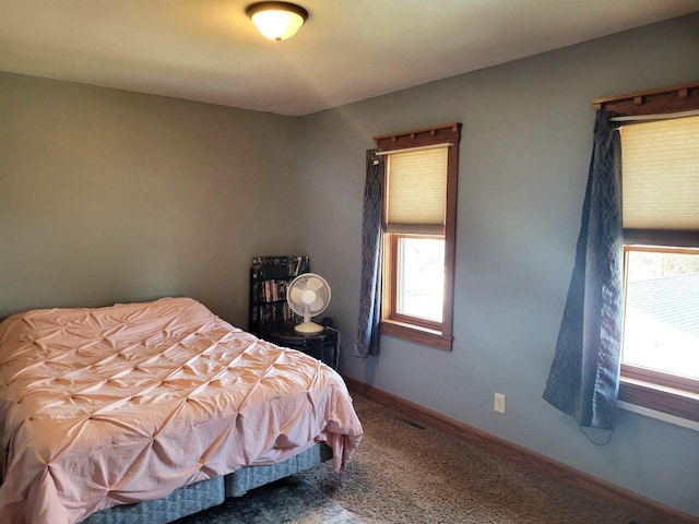 bedroom featuring multiple windows and baseboards