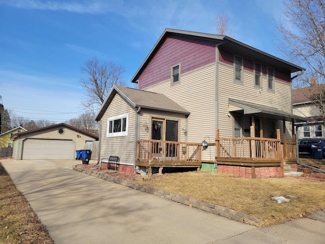 view of front of house featuring an outbuilding, a detached garage, and a shingled roof