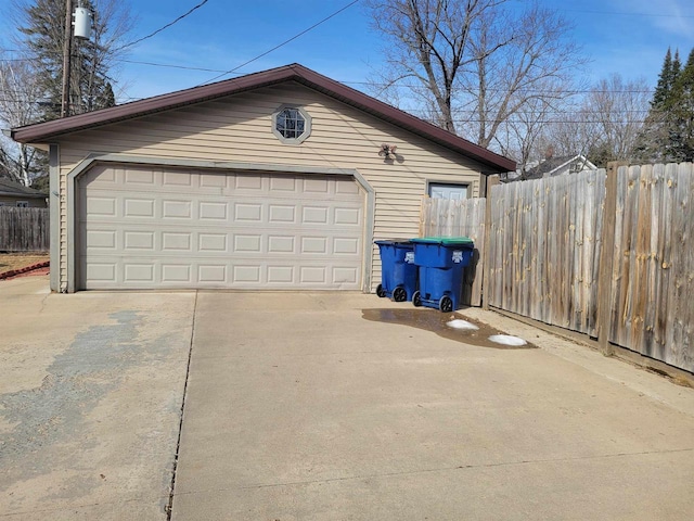 detached garage featuring fence