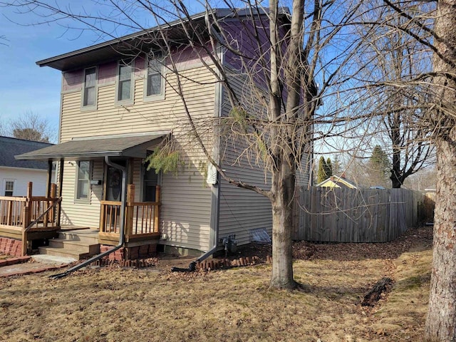 back of house with fence