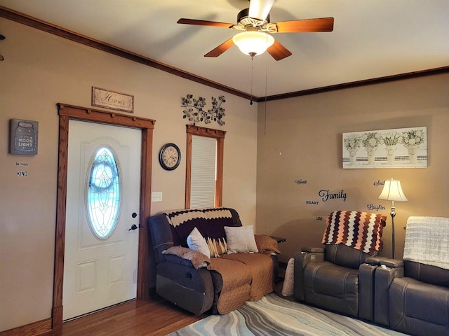 interior space featuring ceiling fan, wood finished floors, and crown molding