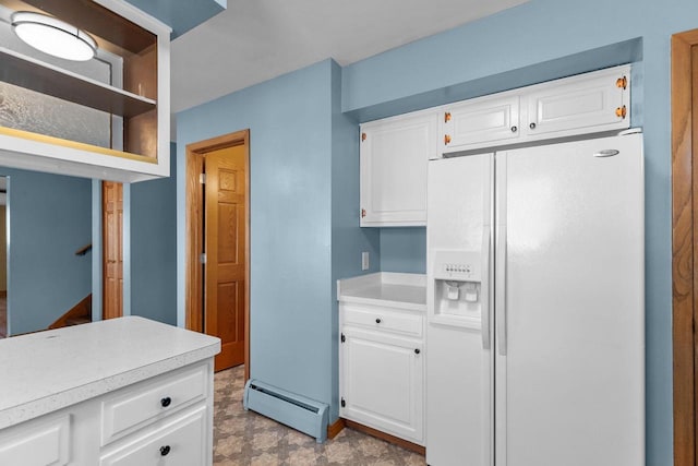 kitchen featuring baseboard heating, white cabinets, light countertops, and white fridge with ice dispenser