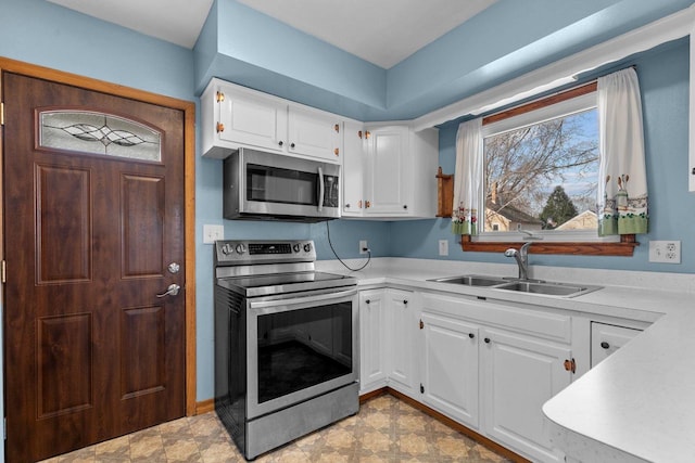 kitchen featuring a sink, light countertops, white cabinets, and stainless steel appliances