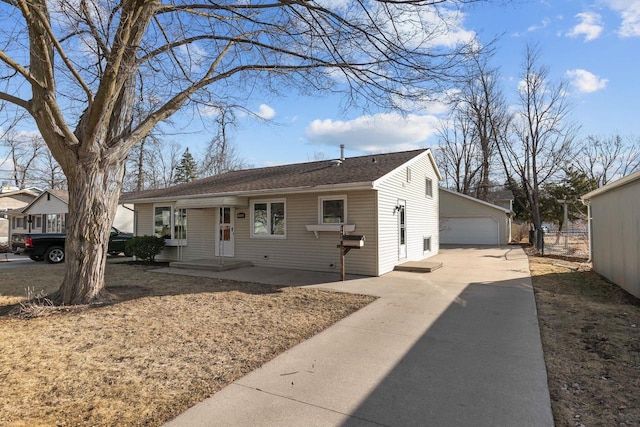 view of front of property featuring a garage and an outdoor structure