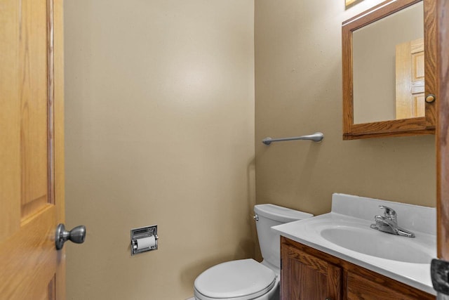 bathroom featuring toilet and vanity