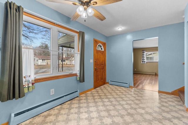 entrance foyer with baseboard heating, light floors, baseboards, and a baseboard radiator