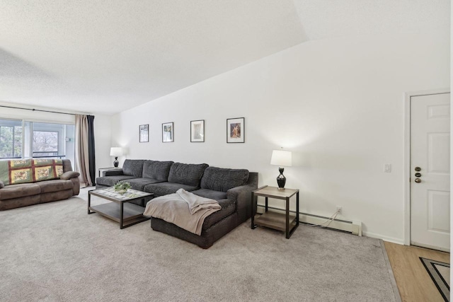 living room with baseboards, light wood-style flooring, vaulted ceiling, a textured ceiling, and a baseboard heating unit