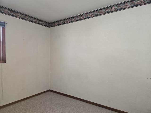 unfurnished room featuring baseboards and carpet flooring