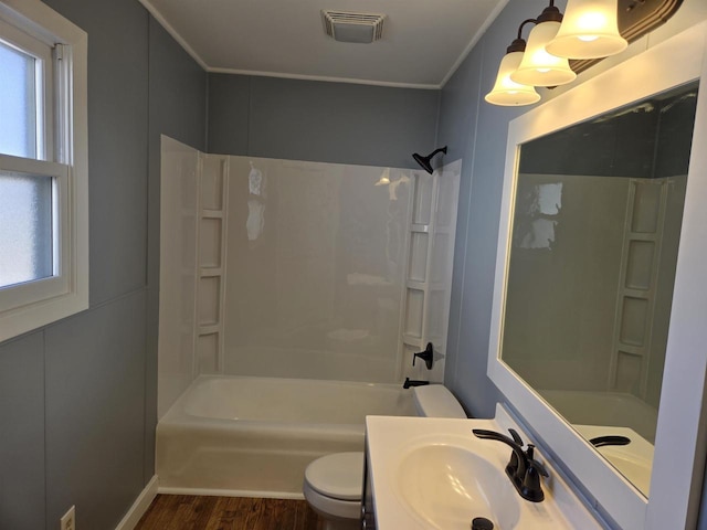 bathroom with visible vents, crown molding, toilet, bathtub / shower combination, and wood finished floors