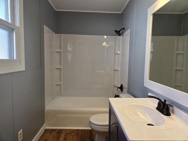 full bath featuring tub / shower combination, toilet, wood finished floors, and vanity