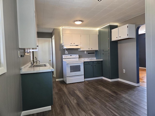 kitchen featuring white range with electric cooktop, under cabinet range hood, light countertops, arched walkways, and a sink