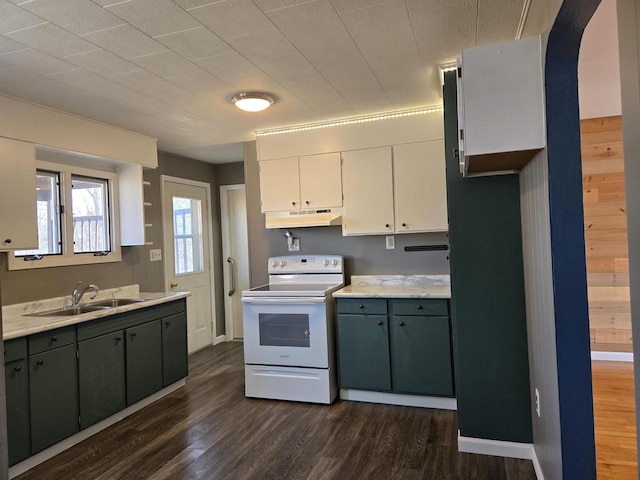 kitchen with dark wood-type flooring, a sink, under cabinet range hood, white range with electric stovetop, and light countertops