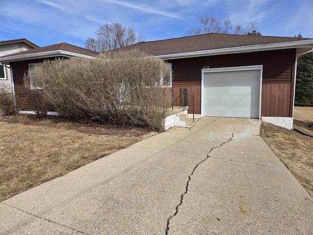 view of property exterior with driveway and a shingled roof