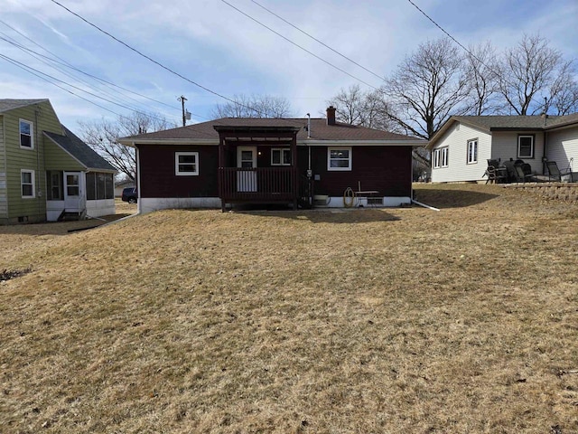 rear view of house featuring a lawn