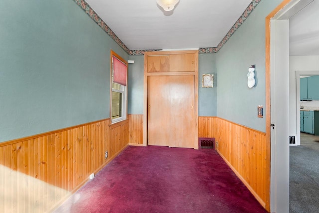 interior space with visible vents, wood walls, and wainscoting