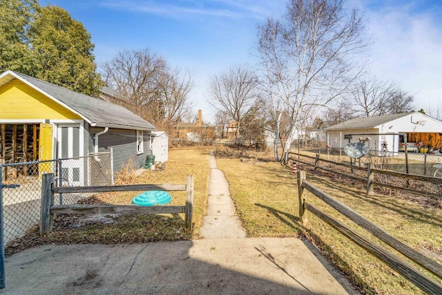 view of yard with an outbuilding and fence