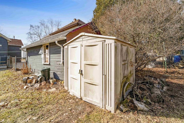 view of shed featuring fence