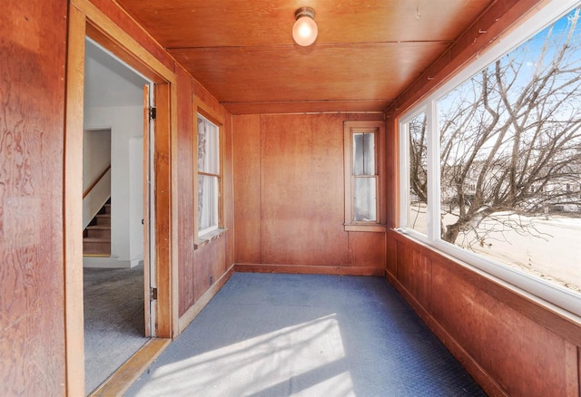 unfurnished sunroom with wood ceiling