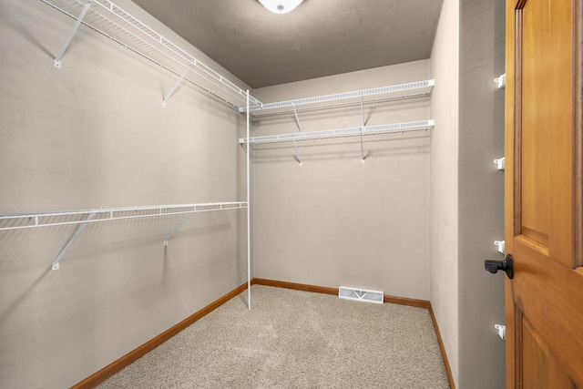 walk in closet with carpet flooring and visible vents