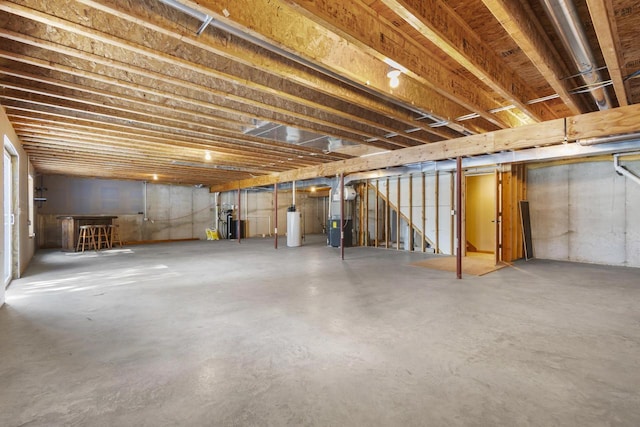 unfinished below grade area featuring gas water heater and water heater