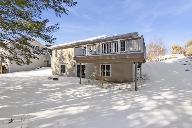 view of snow covered back of property